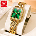 Gold wristwatch with green face on a white cushion, OLEVS brand visible