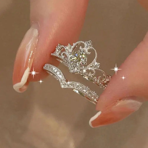 Silver crown-shaped ring on a blurred background