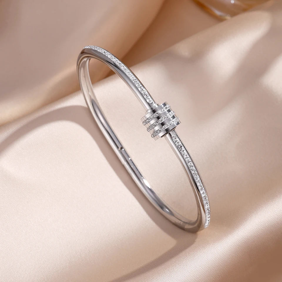 Silver bracelet with small diamonds on a beige fabric background