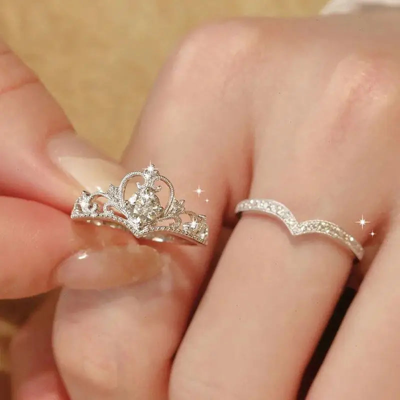 Close-up of two silver rings on fingers with a soft focus background