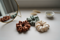 Silk satin scrunchies in earthy tones flat lay